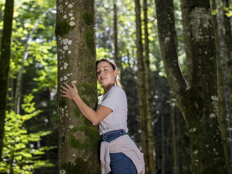 Frau lehnt beim Baum beim Waldbaden | © Urlaub am Bauernhof Oberösterreich / puremotions photography