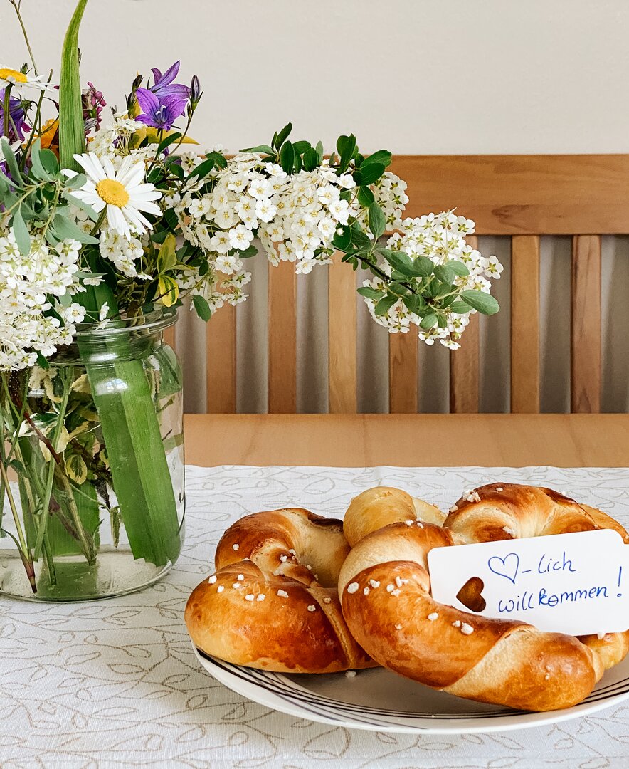 Bunte Blumen in der Vase und süßes Germteig-Gebäck als Willkommensgruß | © Urlaub am Bauernhof Oberösterreich / Theresa Neumüller