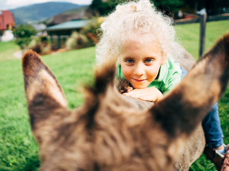 Ein Mädchen sitzt auf einem Esel beim Löckerwirt im SalzburgerLand. | © Urlaub am Bauernhof im SalzburgerLand / Daniel Gollner